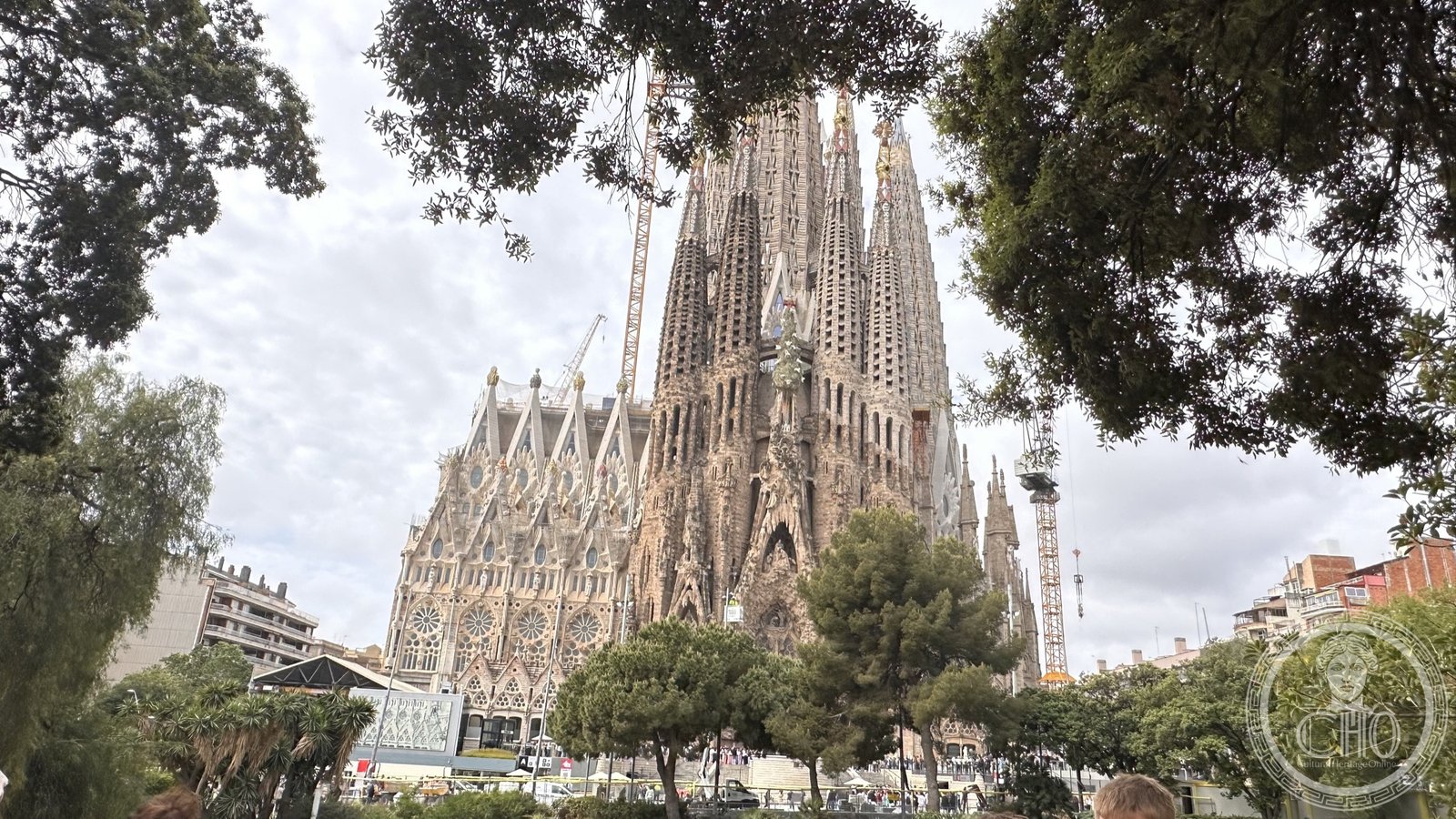 The Sagrada Familia rising above Barcelona, its towers seen across the park